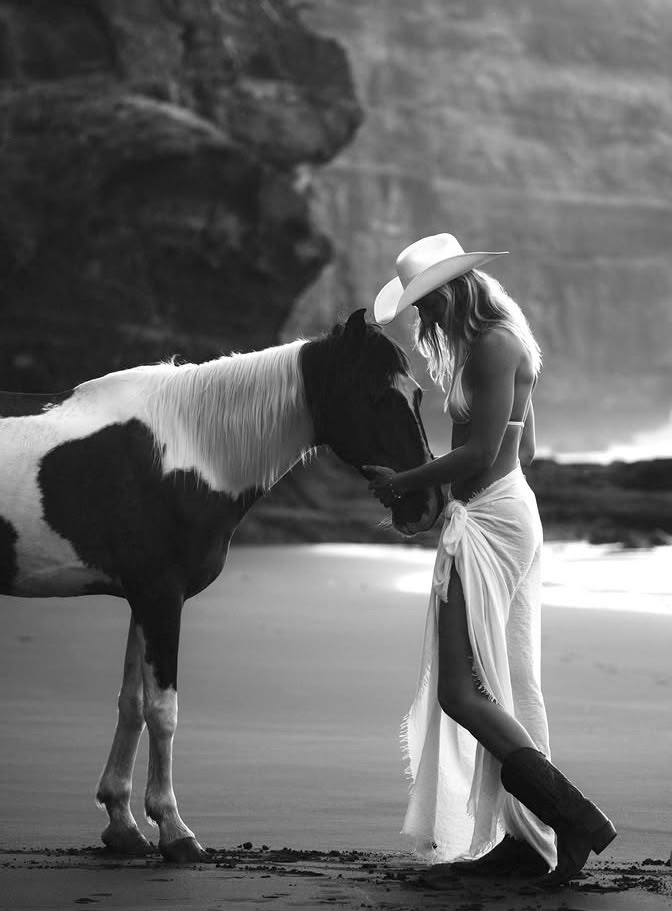 A woman and a horse during a beach photo session